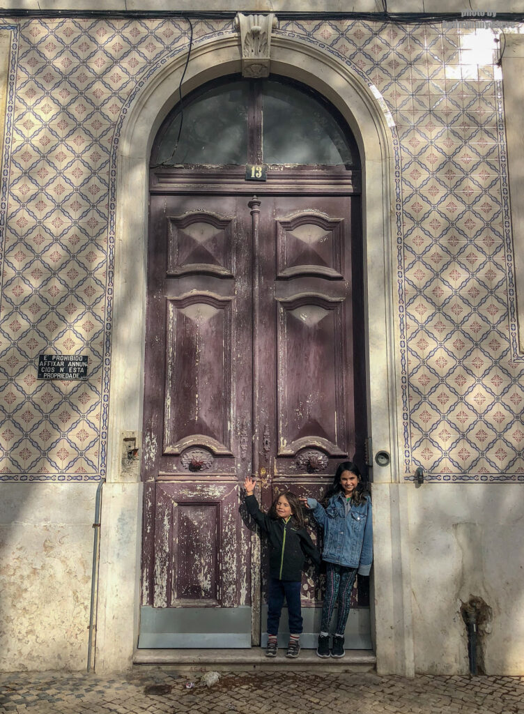 The doors of Lisbon, Barcelona and Paris. This beautiful, purple door my kids are posing in front of, I spotted from the Jardim Nuno Álvares park in the city of Lisbon. My kids were playing in the kids area and I had my eye on this door.