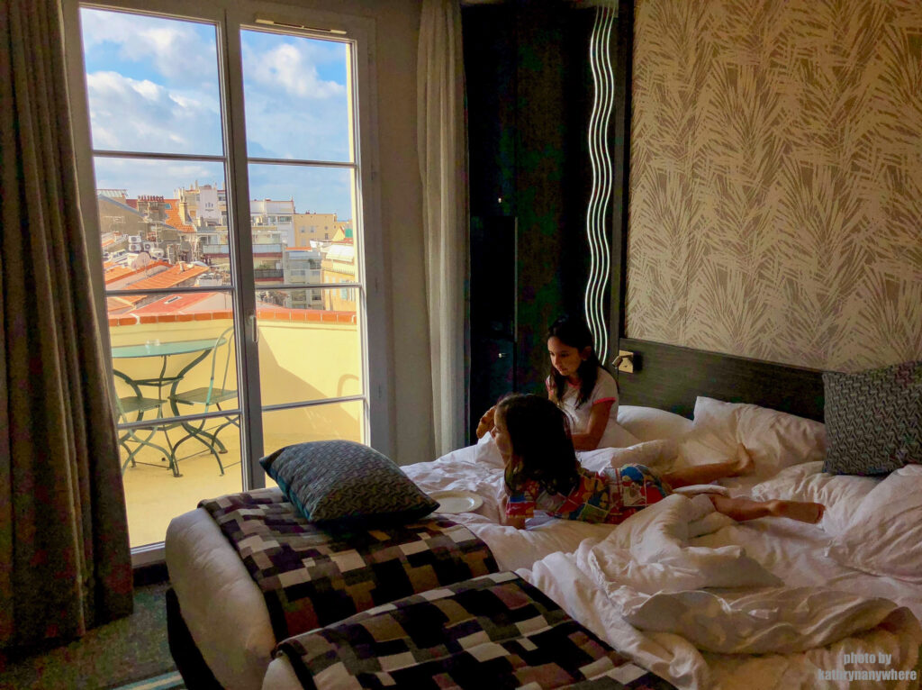 Kids having breakfast in bed at the Best Western Premier Mondial in Cannes, France
