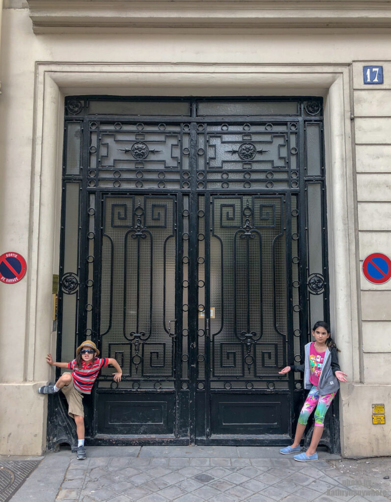Glass door with iron design in Paris. This picture with my children was taken in 7th arrondissement neighbourhood in Paris, France