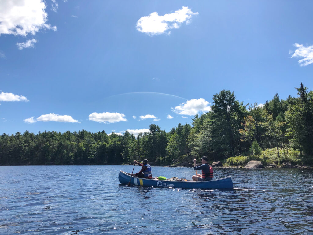 Camping and canoe portage with friends, Kim and Chris in canoe on Serpentine Lake in Kawartha Highlands PP