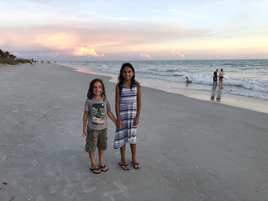 My kids on Sanibel Island at sunset. Visiting Sanibel Island With Kids? You'll want to read this!