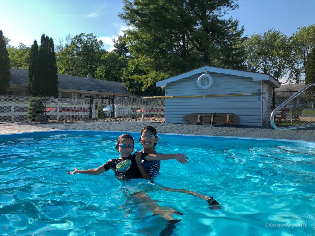 Kids playing in exterior pool at Colonial Resort and Spa in Gananoque