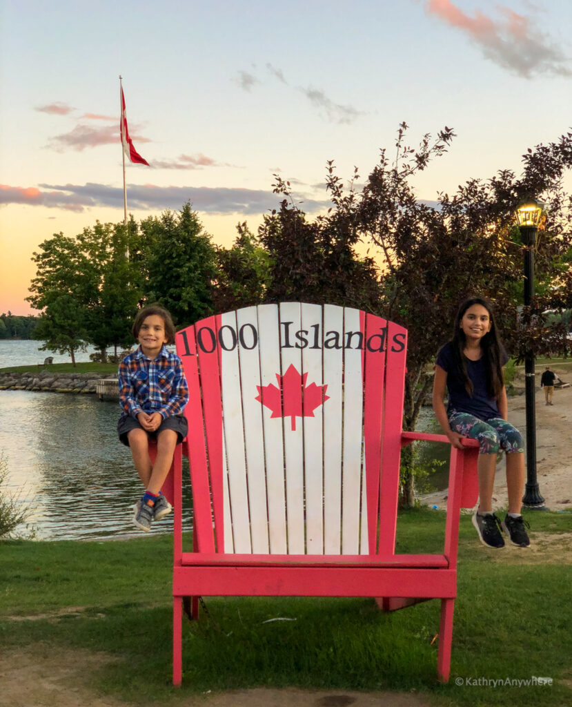 Gananoque, Ontario 1000 Islands kids on large chair with Canadian flag