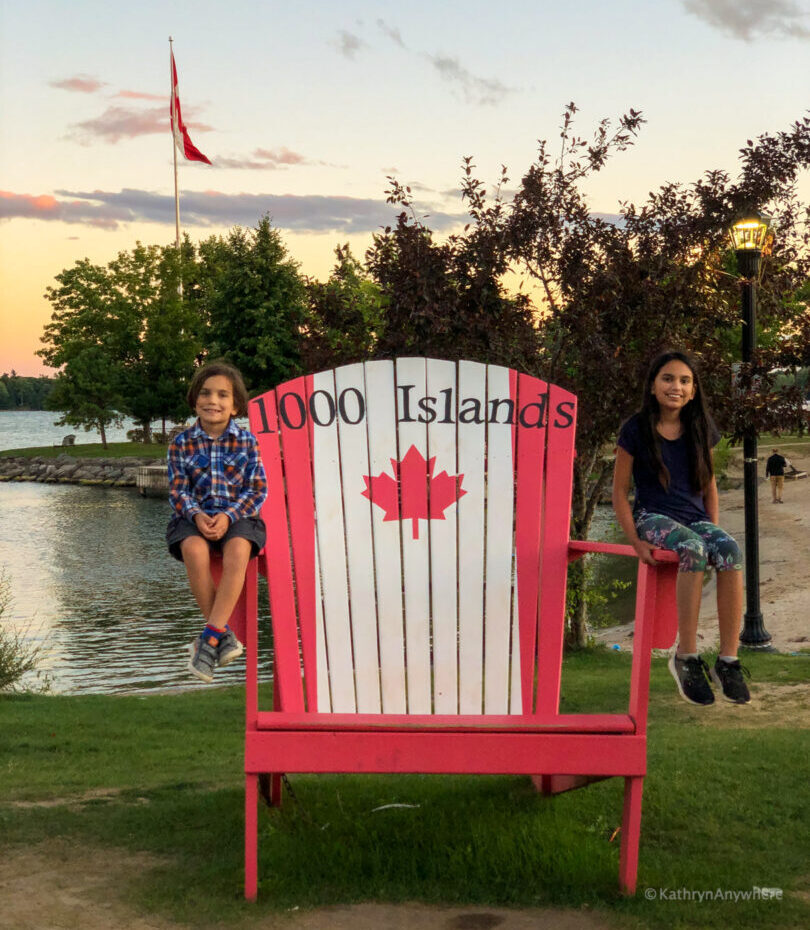 Gananoque, Ontario 1000 Islands kids on large chair with Canadian flag