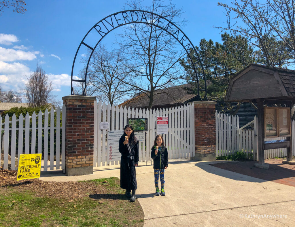 Kids with ice cream cones in front of Riverdale Farm gates in Cabbagetown Toronto