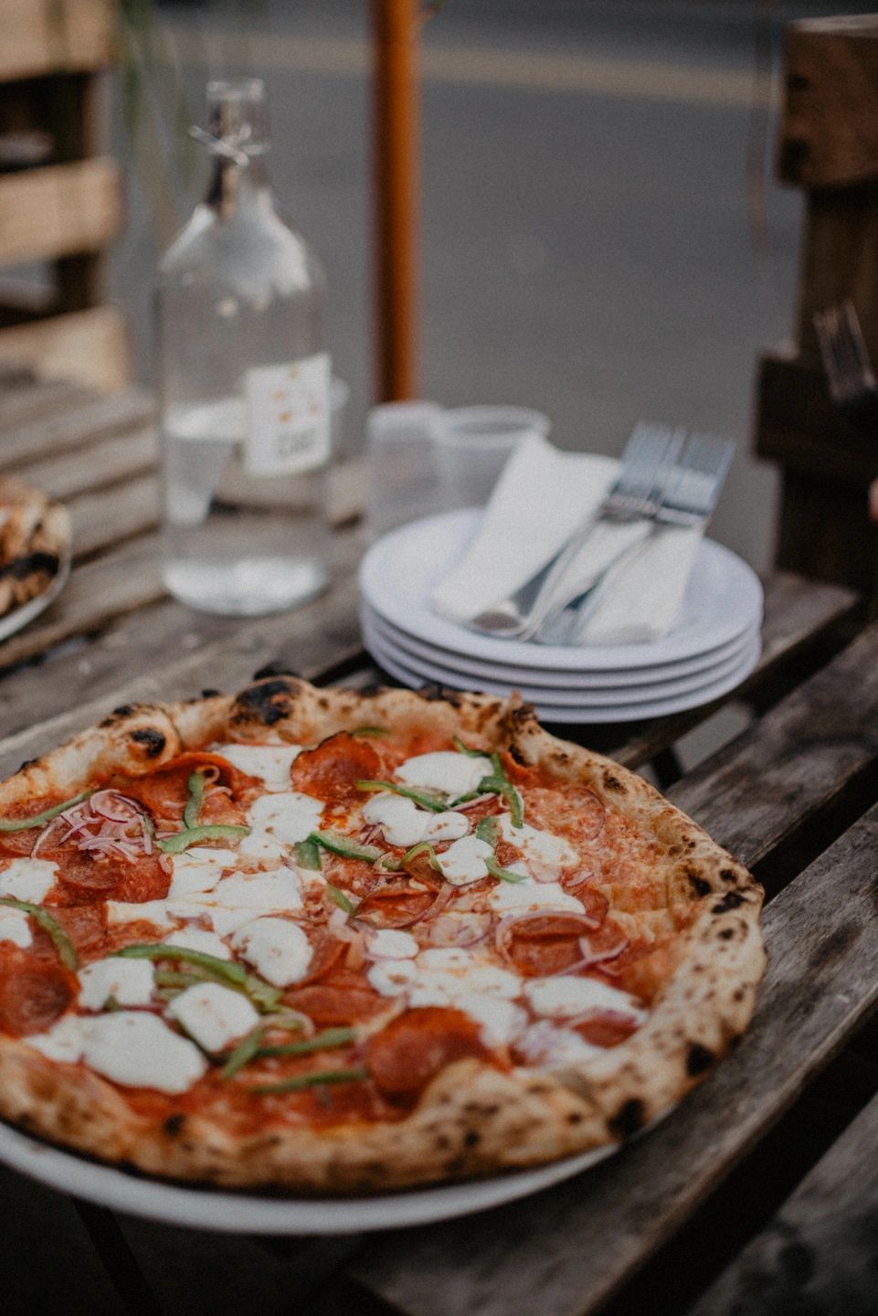 pizza with cheese on a plate on a patio, Restaurants On King Street West - Best Take Out Options in Toronto