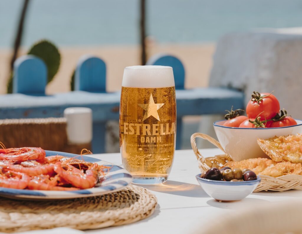 Estrella Damm stock shot on the Mediterranean with food