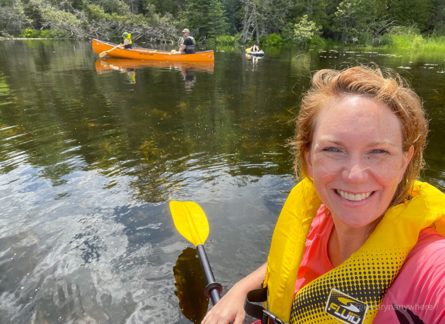 Selfie in a kayak with kids in canoe and on sup in background