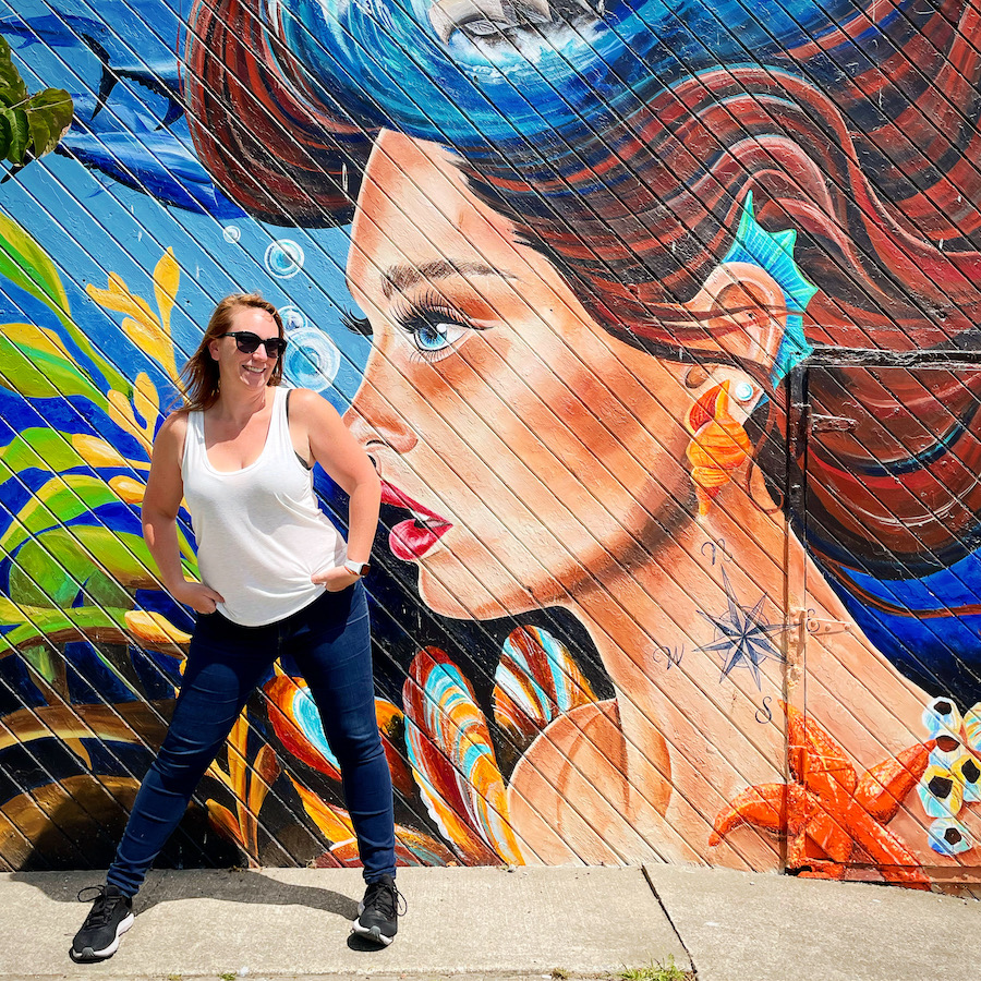 Kathryn at the mural on water street in Yarmouth